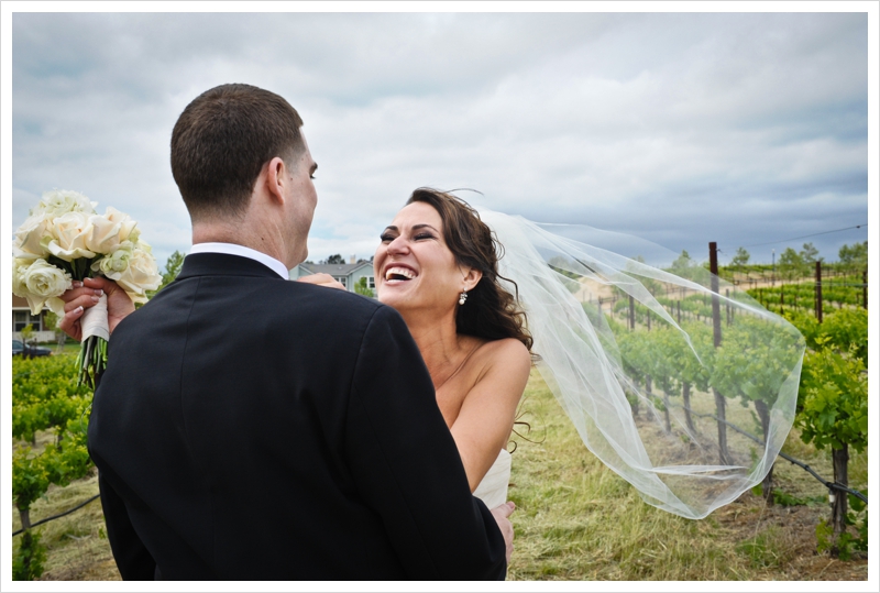 bride and groom embrace in a wine country vineyard